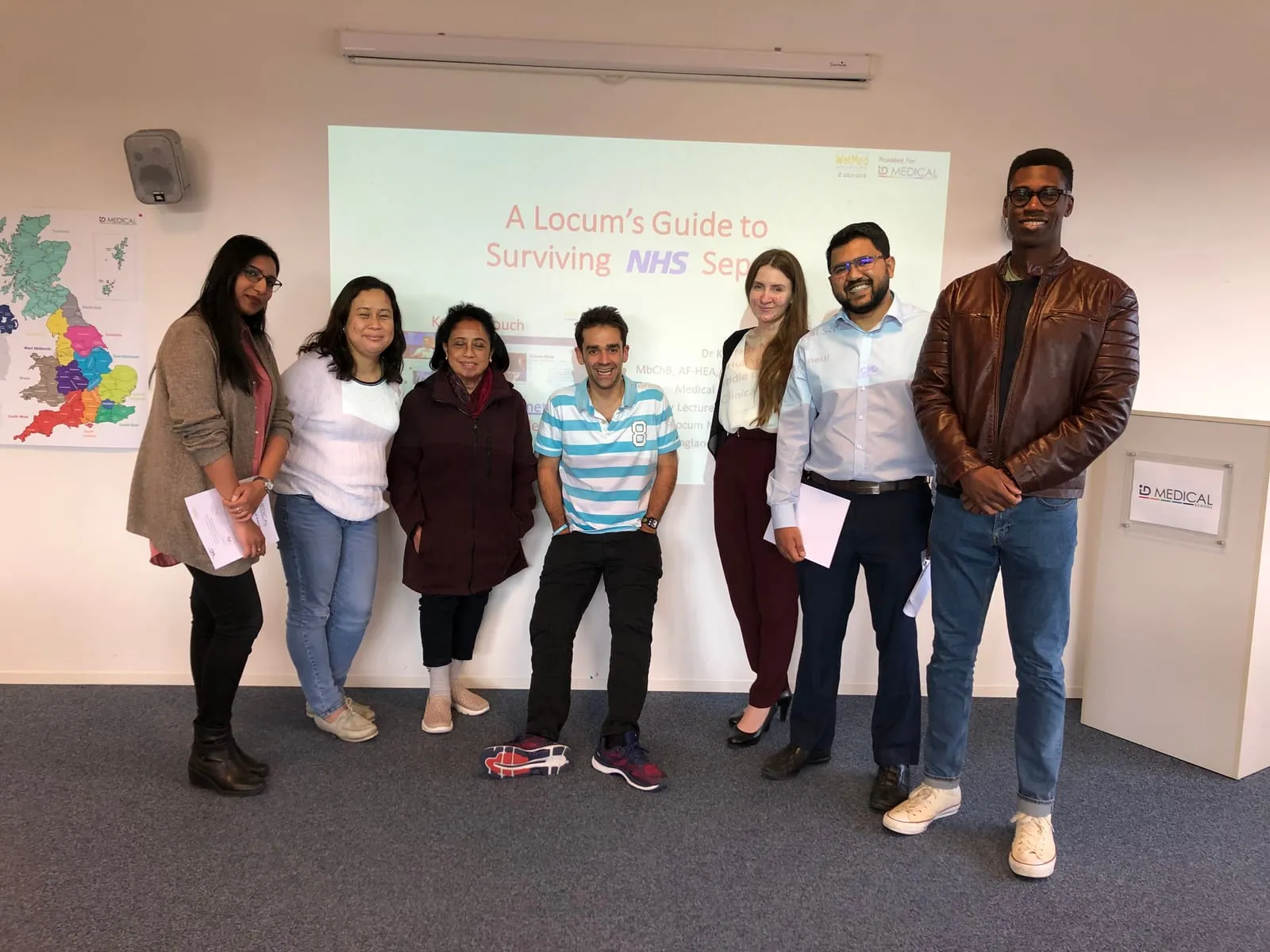 Kishan Rees, in a striped shirt, with course delegates at an ID Medical School teaching session.